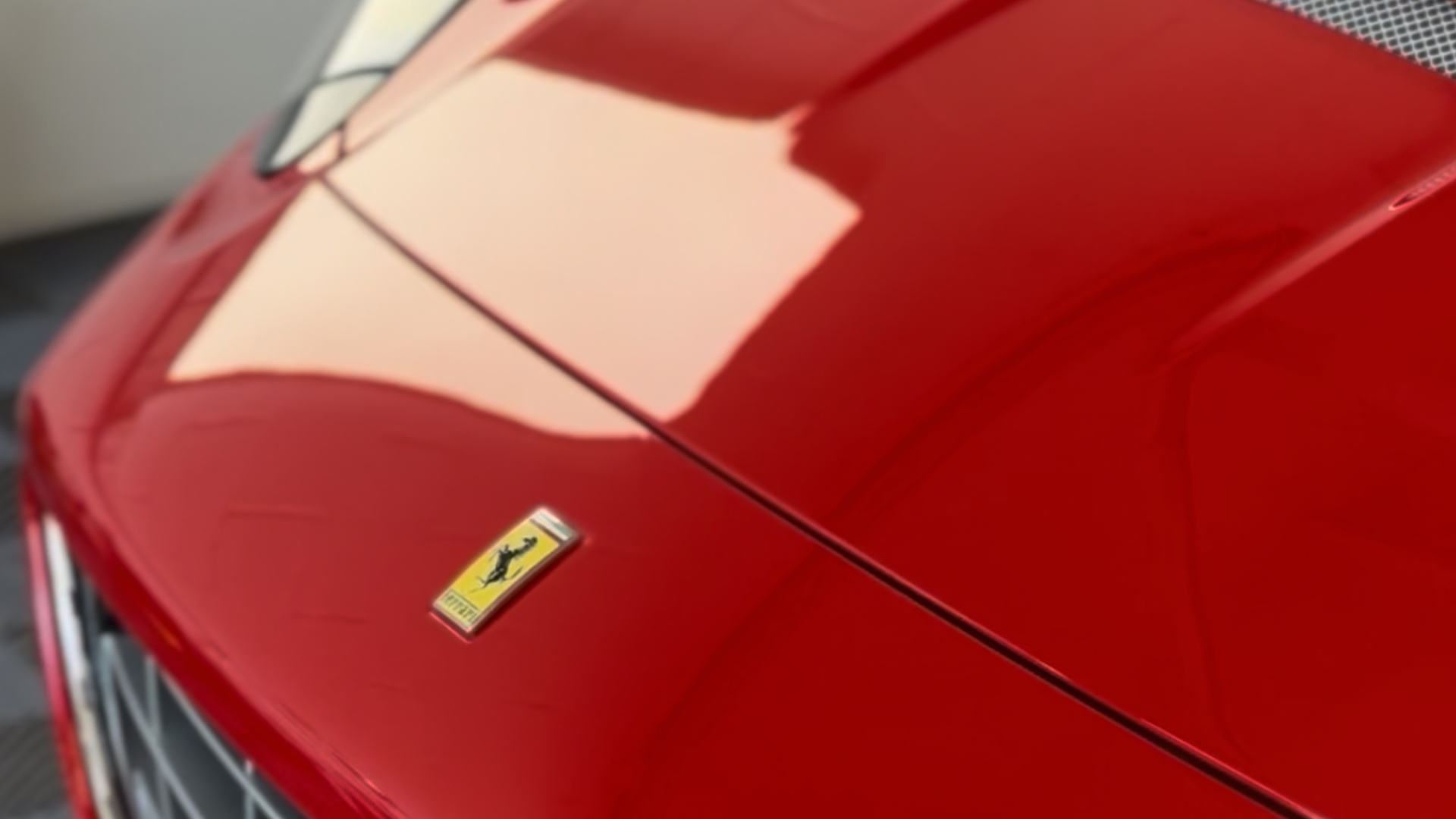 Close view of red Ferrari paintwork under studio lighting